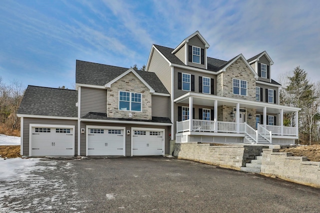 view of front of property featuring aphalt driveway, stone siding, covered porch, a shingled roof, and a garage