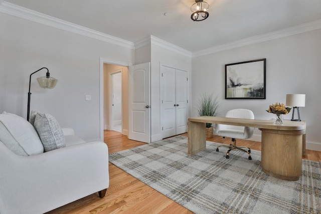 office area with crown molding, baseboards, and wood finished floors