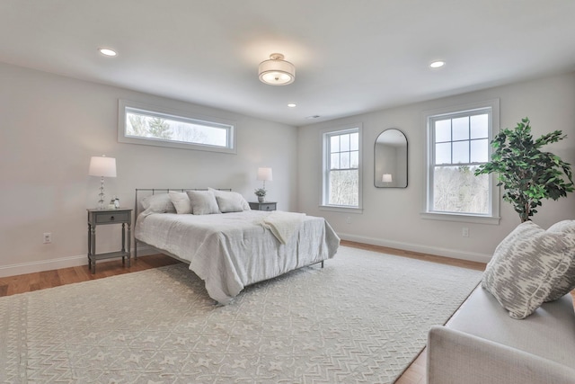 bedroom with recessed lighting, baseboards, and wood finished floors