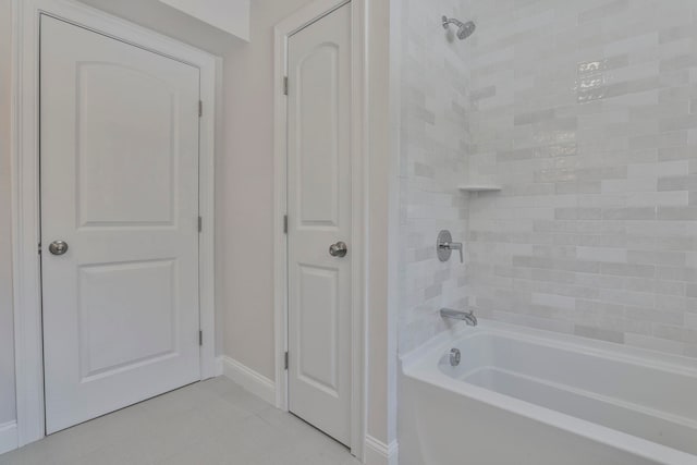 bathroom featuring shower / bathing tub combination and baseboards