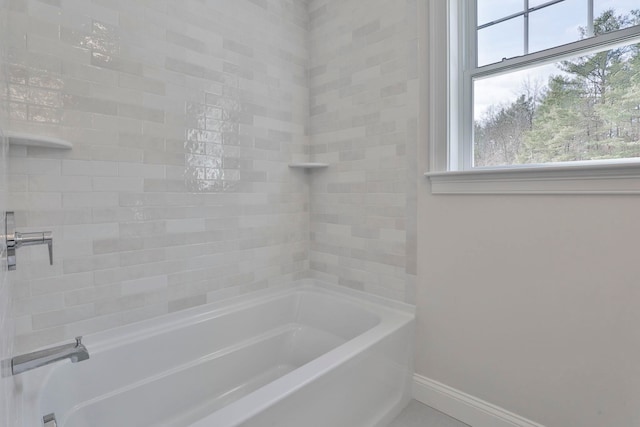 bathroom featuring baseboards and shower / bathtub combination