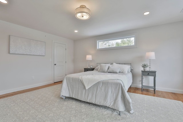 bedroom featuring recessed lighting, wood finished floors, and baseboards