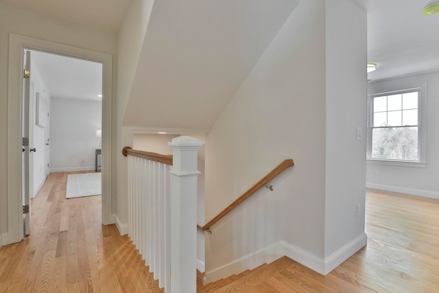 stairs featuring wood finished floors and baseboards