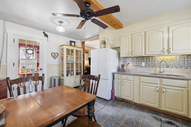 interior space with beamed ceiling and a ceiling fan