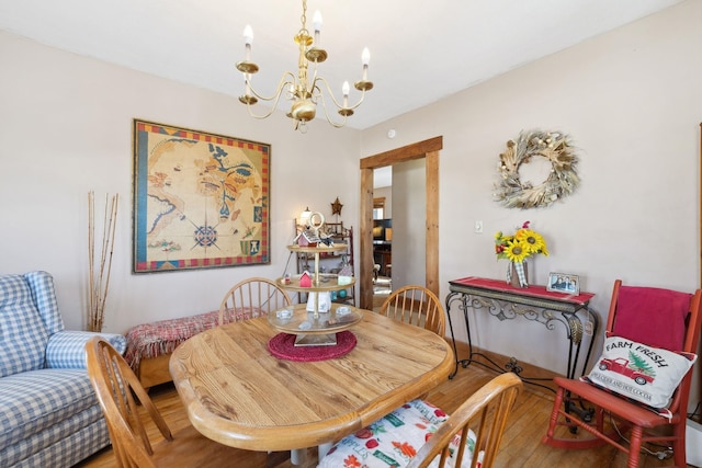 dining space with a notable chandelier and hardwood / wood-style floors