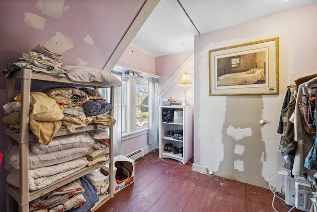 spacious closet with a baseboard heating unit and hardwood / wood-style floors