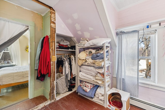 spacious closet with heating unit and baseboard heating