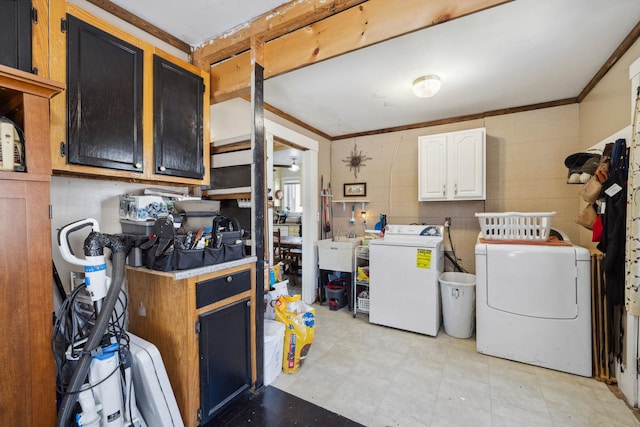 washroom featuring washer and dryer, crown molding, cabinet space, and light floors