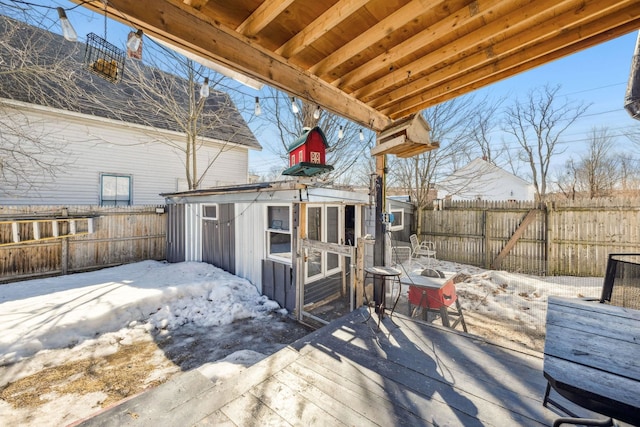 deck featuring a fenced backyard and an outdoor structure