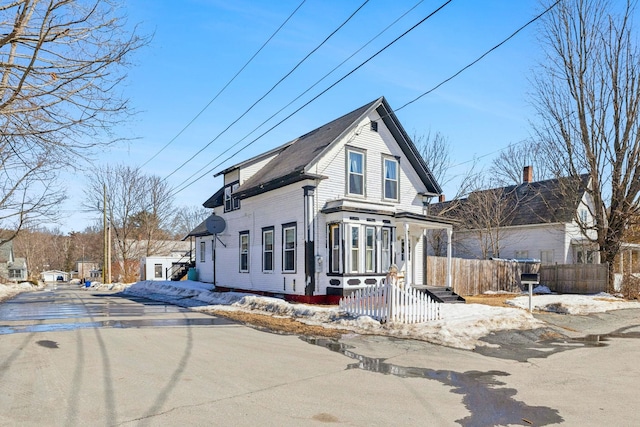 view of front of home featuring fence