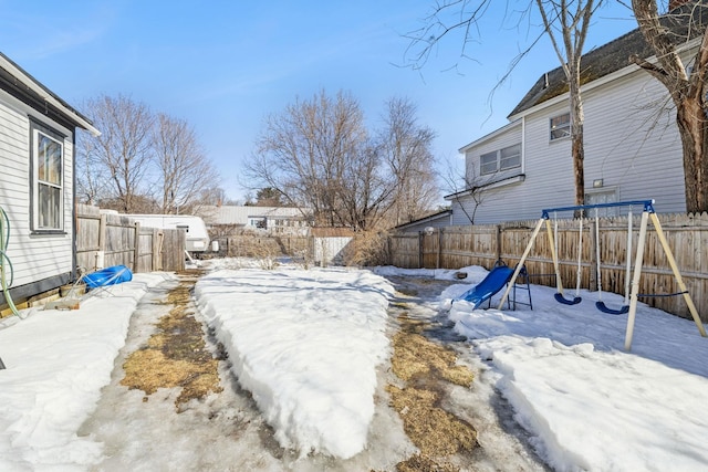 yard covered in snow featuring a fenced backyard