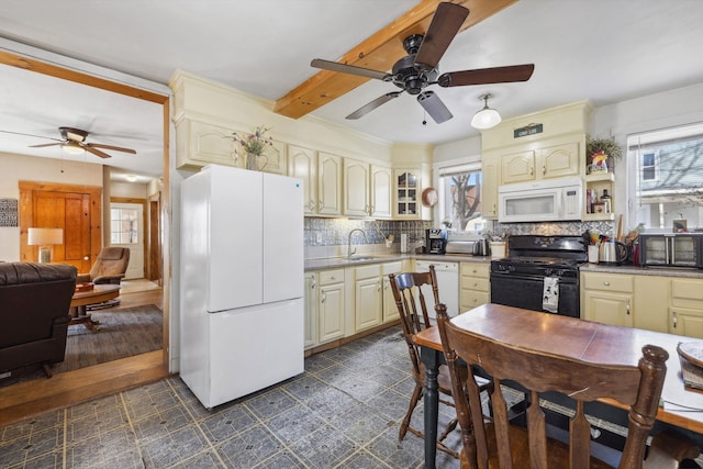 kitchen featuring white appliances, cream cabinets, and ceiling fan