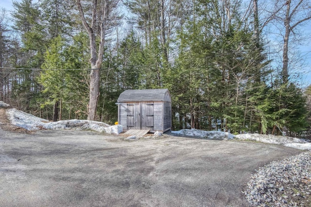 exterior space with a storage shed and an outdoor structure