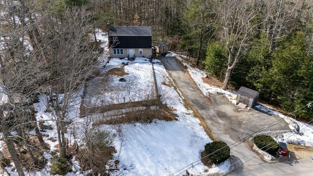 snowy aerial view with a view of trees