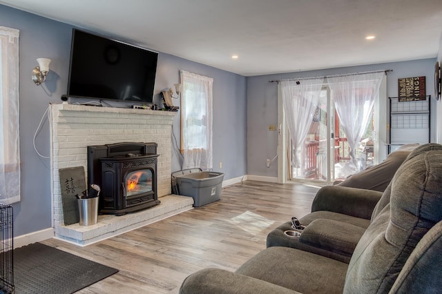 living room featuring a wealth of natural light, baseboards, and wood finished floors