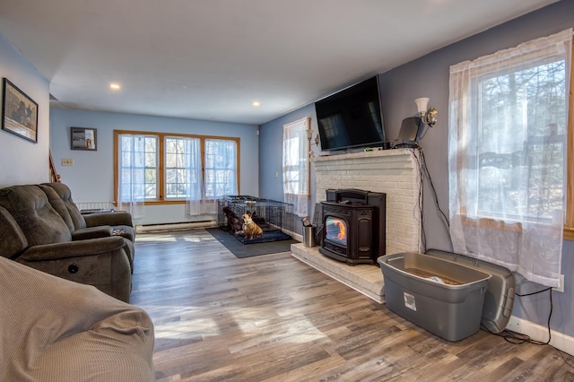 living area featuring wood finished floors, baseboards, and a baseboard radiator