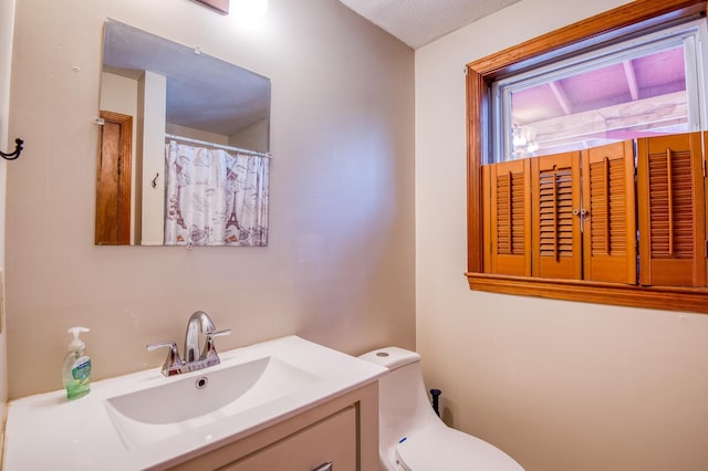 bathroom featuring toilet and vanity