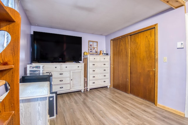 interior space featuring baseboards and wood finished floors