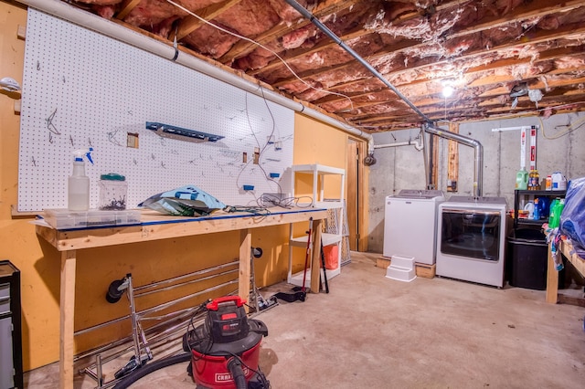 unfinished basement featuring a workshop area and independent washer and dryer