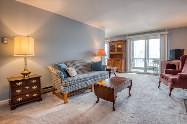 living area featuring a baseboard heating unit and carpet