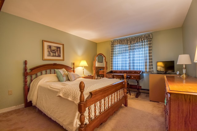 bedroom featuring light colored carpet and baseboards