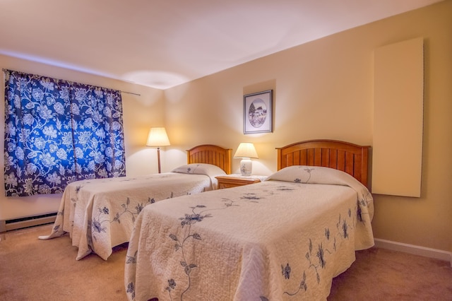 carpeted bedroom with a baseboard radiator and baseboards