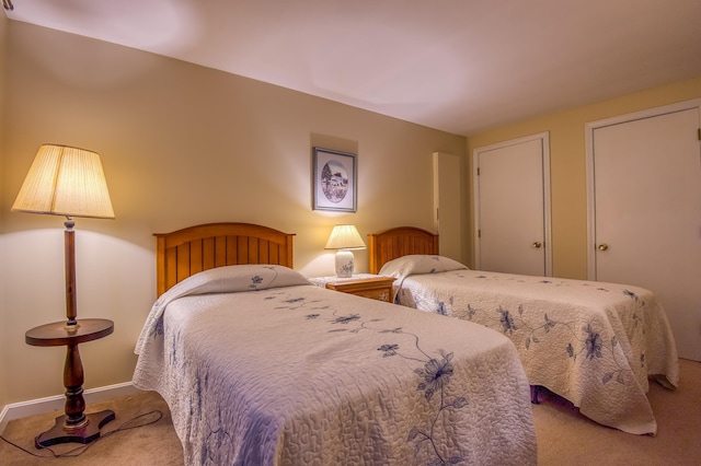 carpeted bedroom featuring baseboards