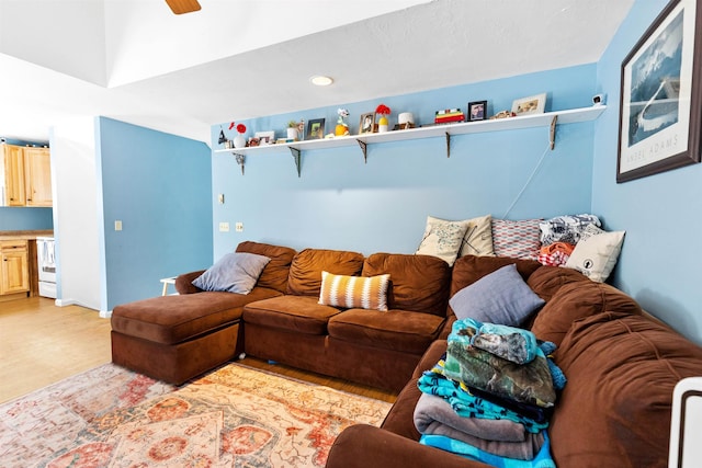 living area with a ceiling fan and light wood-style floors