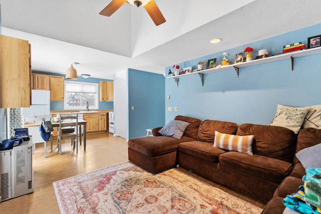 living room featuring light wood-style flooring and a ceiling fan