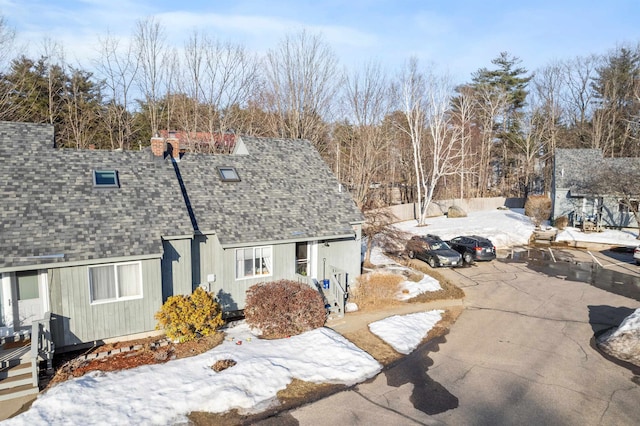 exterior space featuring a shingled roof