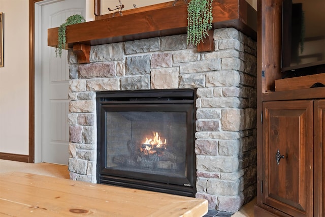 interior details with a glass covered fireplace