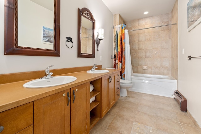 bathroom featuring double vanity, toilet, shower / tub combo, and a sink