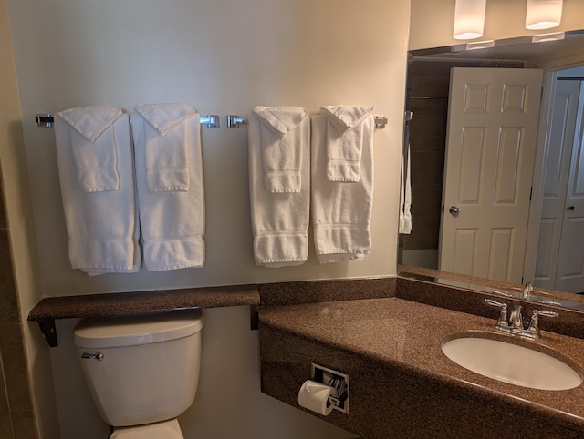 bathroom featuring toilet and vanity