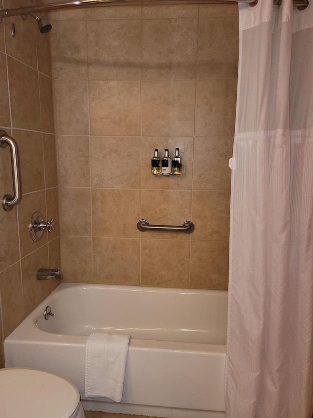 bathroom featuring toilet and shower / bathtub combination with curtain