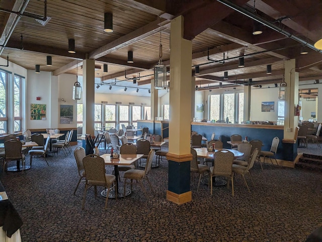 dining space featuring plenty of natural light, beam ceiling, and wooden ceiling