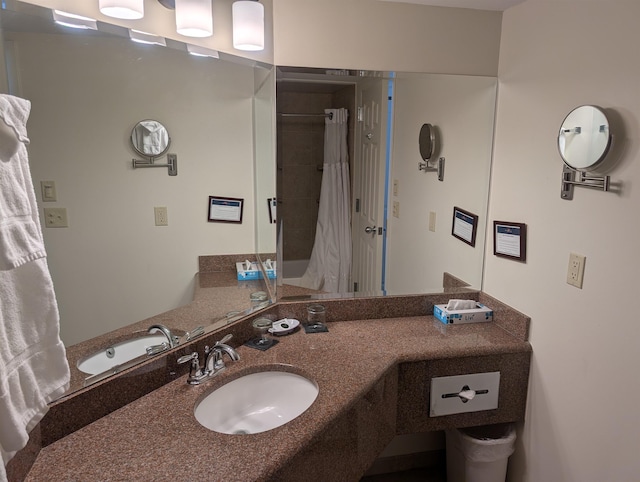 full bathroom with a shower with shower curtain and vanity