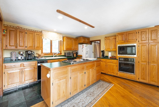 39 Birch Glen Dr, Bennington, NH 03442 - kitchen with black oven, built in microwave, stainless steel gas cooktop, white fridge with ice dispenser, and a sink