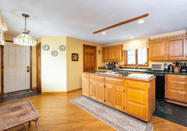 39 Birch Glen Dr, Bennington, NH 03442 - kitchen with dishwasher, light wood-style flooring, stainless steel gas stovetop, a textured ceiling, and a sink