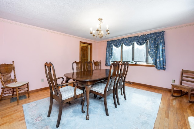 39 Birch Glen Dr, Bennington, NH 03442 - dining space featuring light wood-style floors, baseboards, a notable chandelier, and a textured ceiling