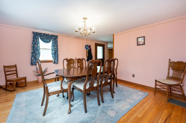 39 Birch Glen Dr, Bennington, NH 03442 - dining room featuring baseboards, light wood-style floors, and an inviting chandelier