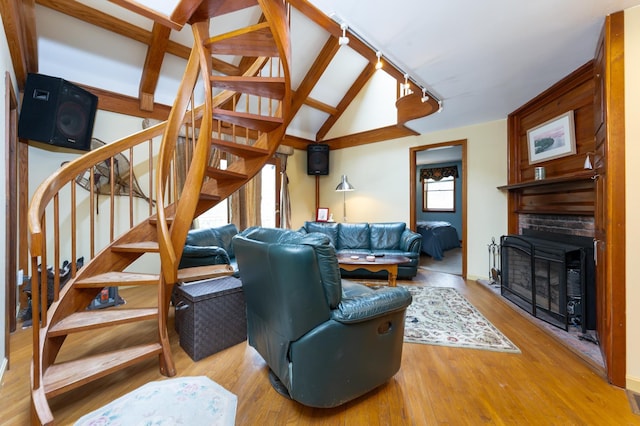 39 Birch Glen Dr, Bennington, NH 03442 - living room with stairs, lofted ceiling with beams, rail lighting, a fireplace, and wood finished floors