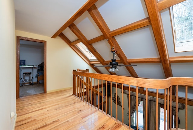 39 Birch Glen Dr, Bennington, NH 03442 - stairway with lofted ceiling with skylight, baseboards, a ceiling fan, and wood finished floors