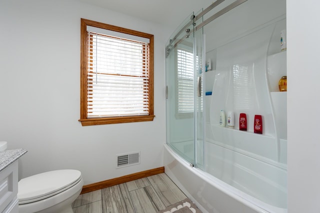 39 Birch Glen Dr, Bennington, NH 03442 - bathroom with vanity, baseboards, visible vents, enclosed tub / shower combo, and toilet