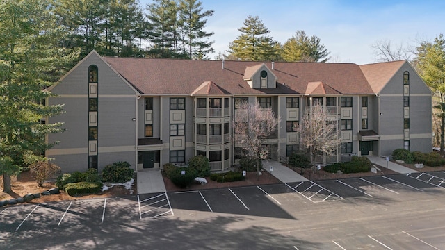 view of building exterior featuring uncovered parking