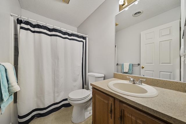 bathroom with visible vents, toilet, vanity, a shower with shower curtain, and a textured ceiling