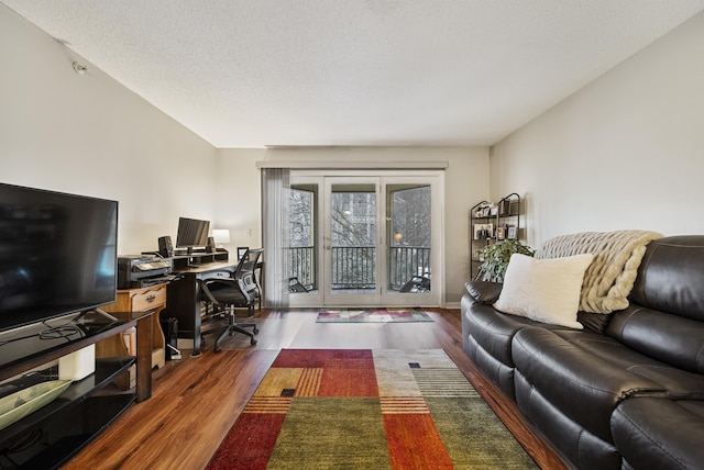 living room featuring a textured ceiling and wood finished floors