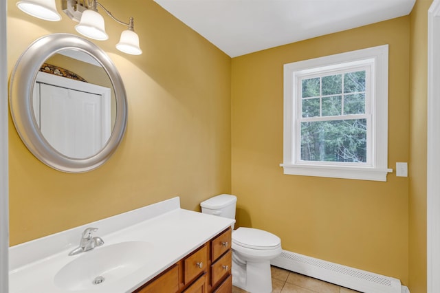 bathroom featuring vanity, baseboards, a baseboard radiator, tile patterned floors, and toilet