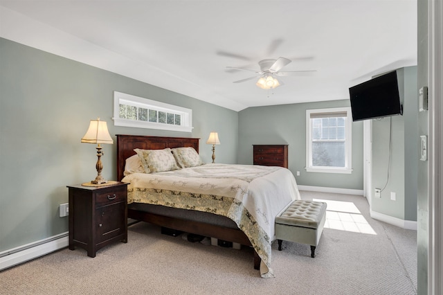 bedroom featuring baseboards, multiple windows, baseboard heating, and light colored carpet