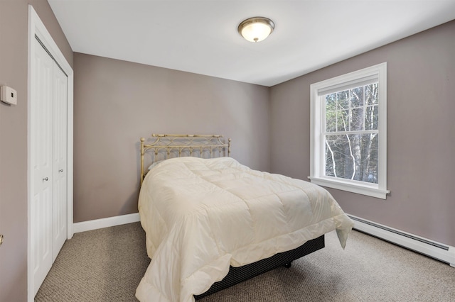 carpeted bedroom featuring baseboards, a closet, and a baseboard radiator