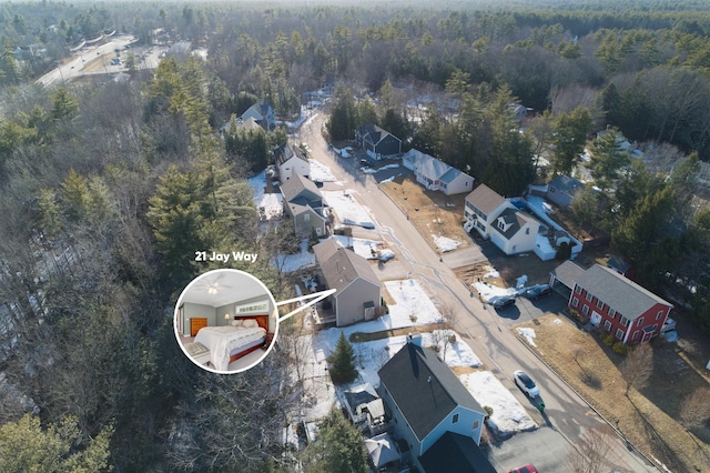 birds eye view of property with a view of trees